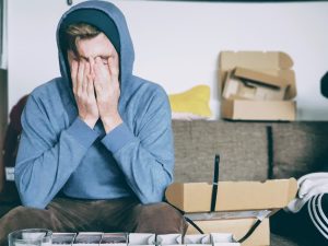 worried young man with boxes